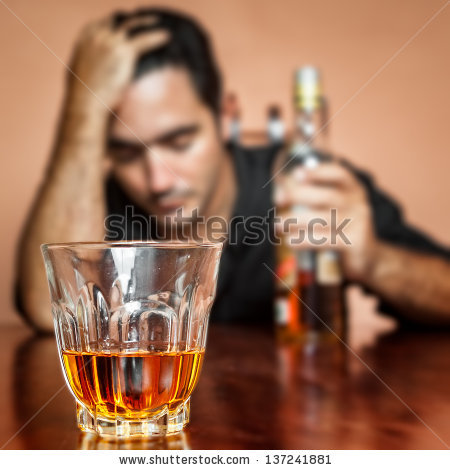 -drunk-and-lonely-latin-man-holding-a-rum-or-whiskey-bottle-image-focused-on-his-drink-137241881.jpg